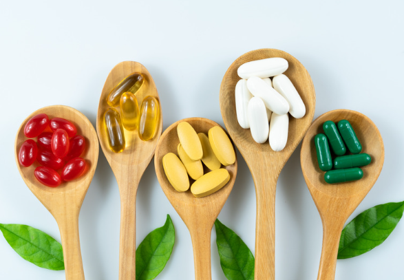 wooden spoons holding supplements