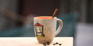 Tea cup with stick of cinnamon protruding out