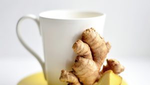 Tea cup with fresh ginger root