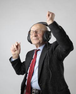 Man with headphones on dancing with smile