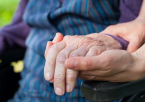 Hands holding in wheelchair