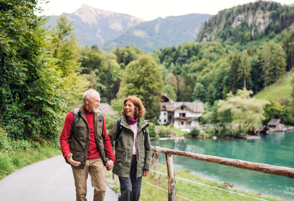 Elderly couple walking by the lake