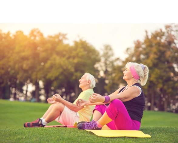 Elderly couple enjoying yoga outside