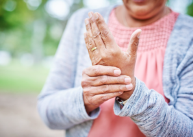 Elderly woman rubbing her hand