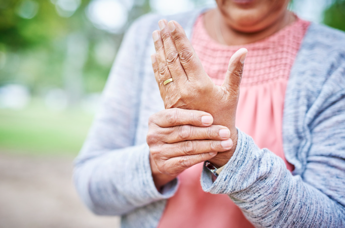 Elderly woman rubbing her hand