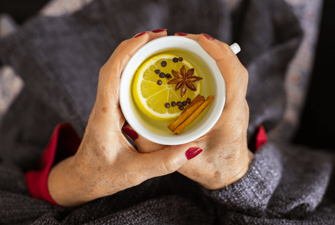 Elderly woman drinking herbal tea