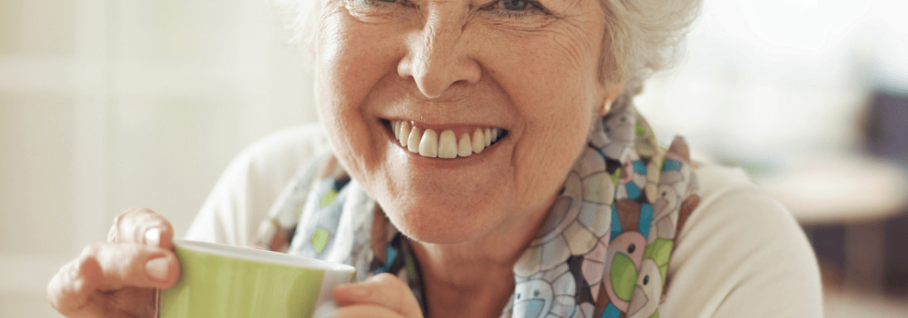 Elderly woman drinking a cup of green tea