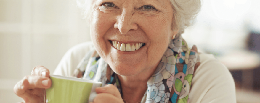 Elderly woman drinking a cup of green tea