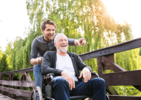 Son pushing fathers on a wheelchair