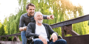 Son pushing fathers on a wheelchair