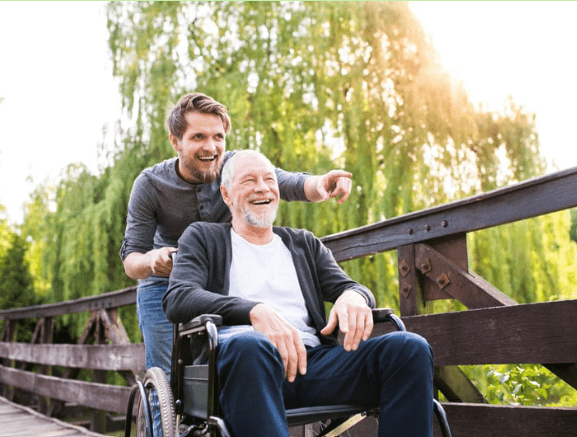 Son pushing fathers on a wheelchair