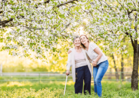 Elderly woman and young woman enjoying the spring blooms