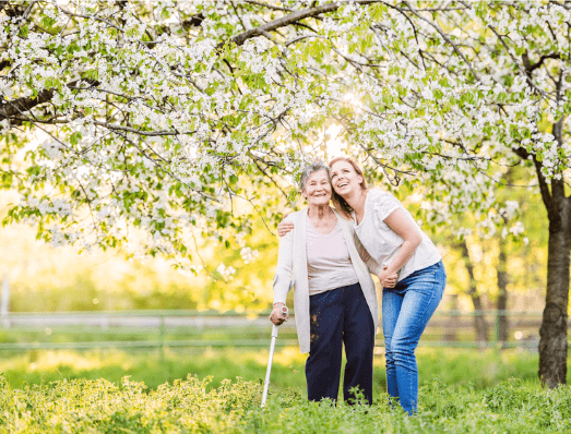 Elderly woman and young woman enjoying the spring blooms