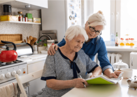 Adult woman in the kitchen with her elderly mother