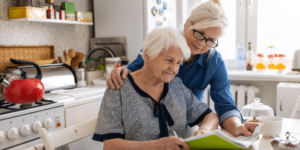 Adult woman in the kitchen with her elderly mother