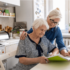 Adult woman in the kitchen with her elderly mother