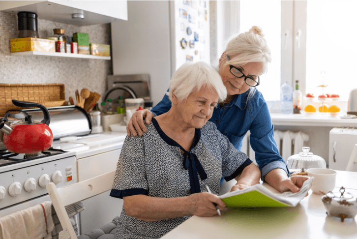 Adult woman in the kitchen with her elderly mother