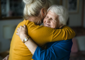 Elderly mother hugging your adult daughter