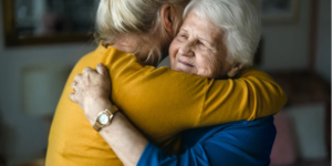 Elderly mother hugging your adult daughter