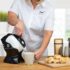 Woman using the tilt-to-pour action of the Uccello Kettle