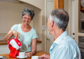 Elderly Man and Woman enjoying a cup of tea together