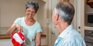 Elderly Man and Woman enjoying a cup of tea together