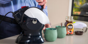 Elderly man pouring the Uccello Kettle in the kitchen